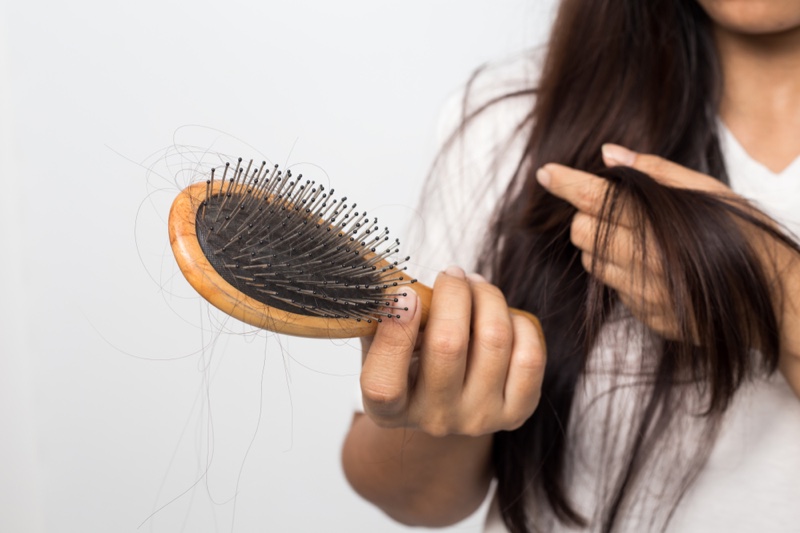 Woman Hair Loss Brush Concept