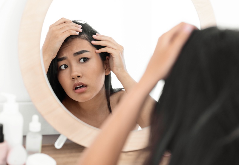 Worried Asian Woman Looking Hair Line Mirror