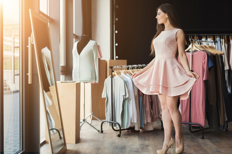 Attractive Woman Trying Pink Dress Mirror Store