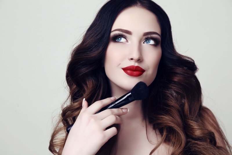 Beauty Model Red Lipstick Holding Makeup Brush