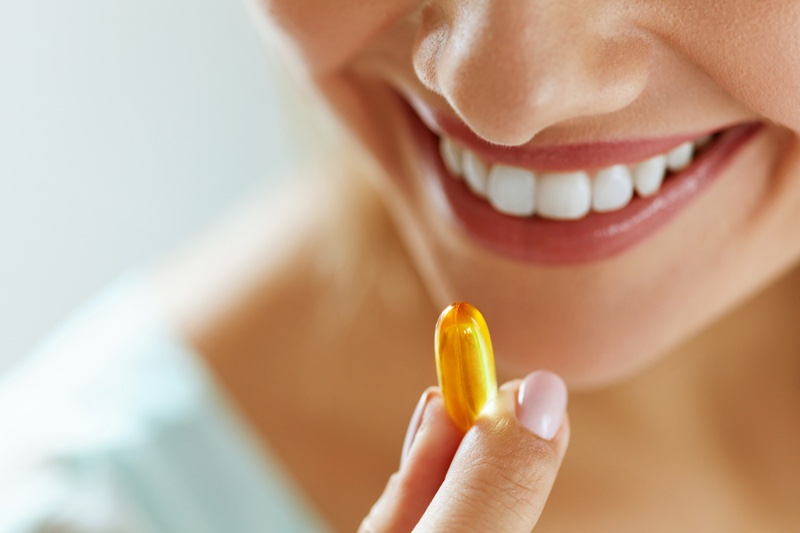 Cropped Woman Taking Capsule Gel Pill