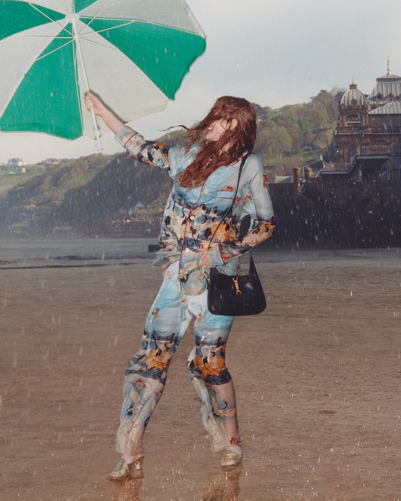 A model poses with an umbrella in Gucci Towards the Sun summer 2021 campaign.