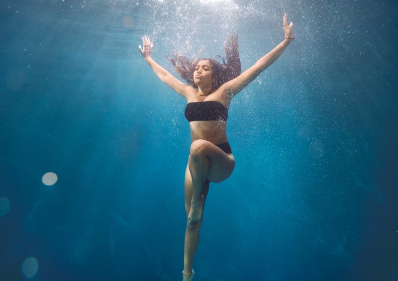 Nouri Hassan poses underwater for H&M summer 2021 swimwear campaign.