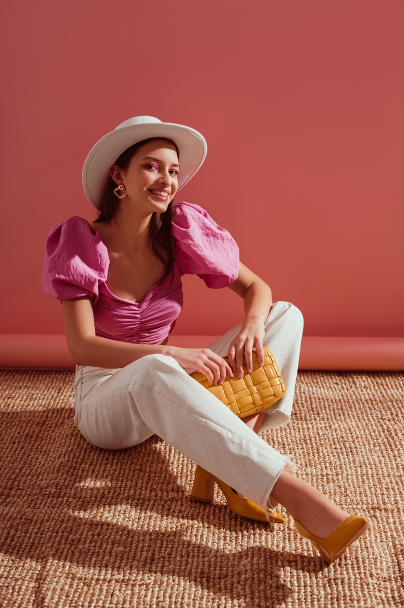 Model Pink Puff Sleeve Top White Jeans Hat Yellow bag Trendy Outfit
