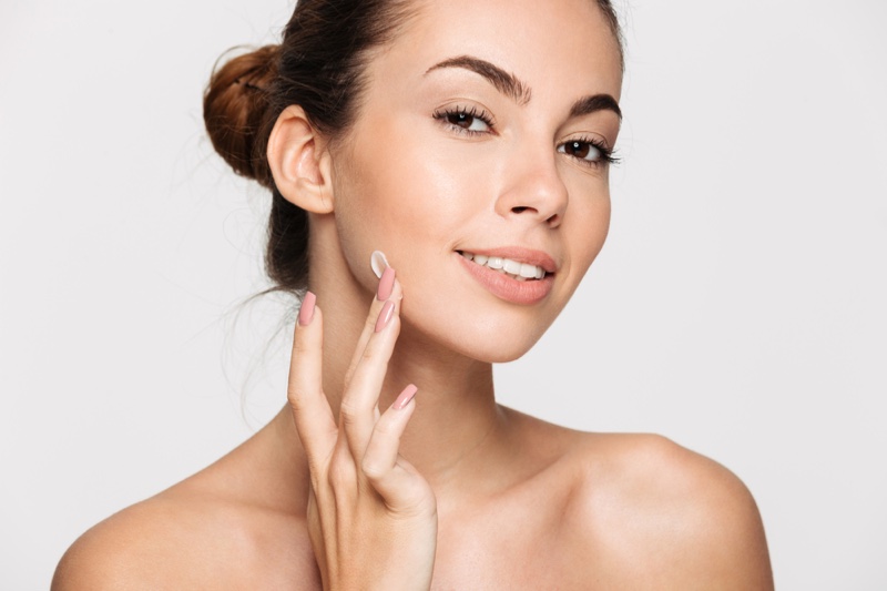 Model applying Skin Cream Face