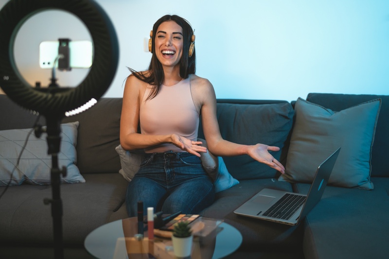 Smiling Woman Recording Video vlogger Couch