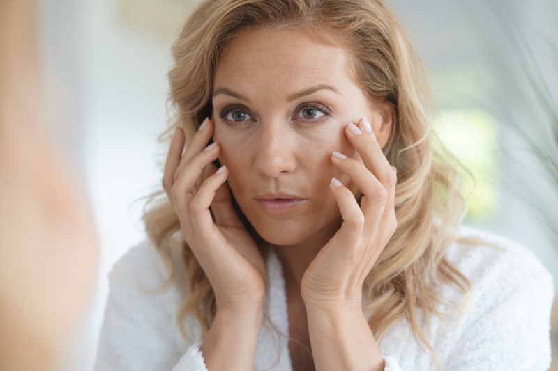 Woman Applying Anti-Aging Cream Face