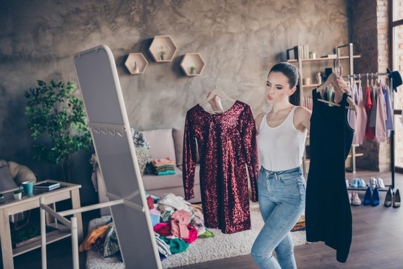 Woman Looking at Dresses at Home