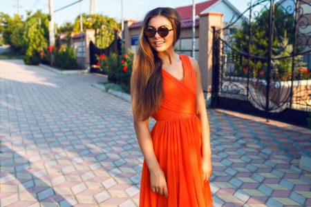 Accessories To Beat the Heat and Stay Cool Woman Orange Dress Summer Sunglasses