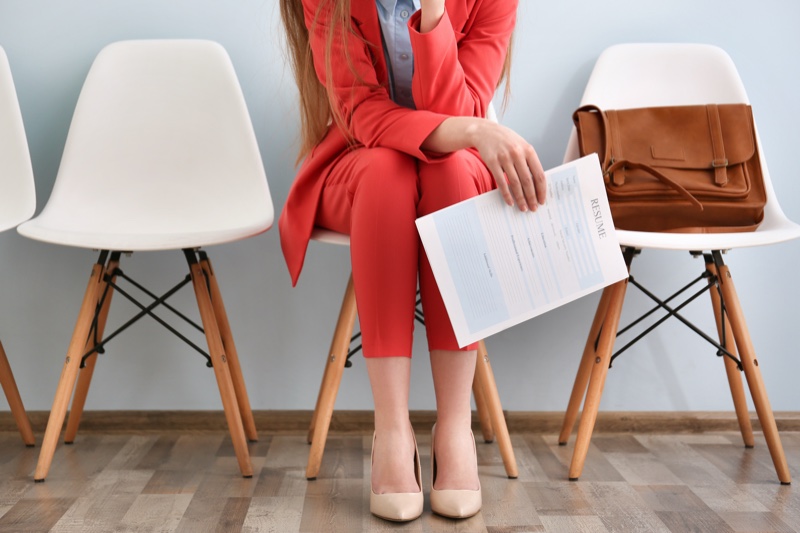 Woman Sitting Red Pant Suit Fashion Holding Resume Cropped