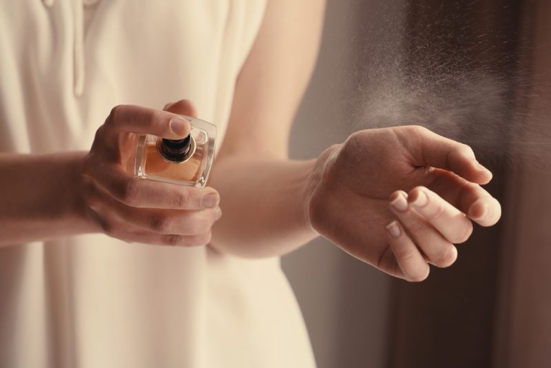 Woman Spraying Perfume on Wrist