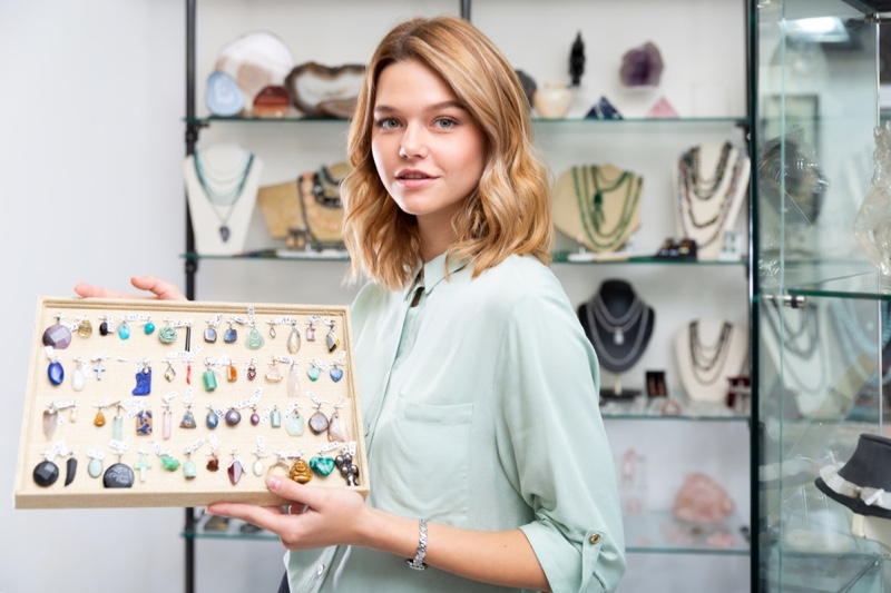 Young Woman Holding Various Gemstone Jewelry Collection Store
