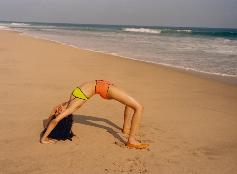 Model wears Zara bandeau bikini top and high-waisted bikini bottoms with piping.