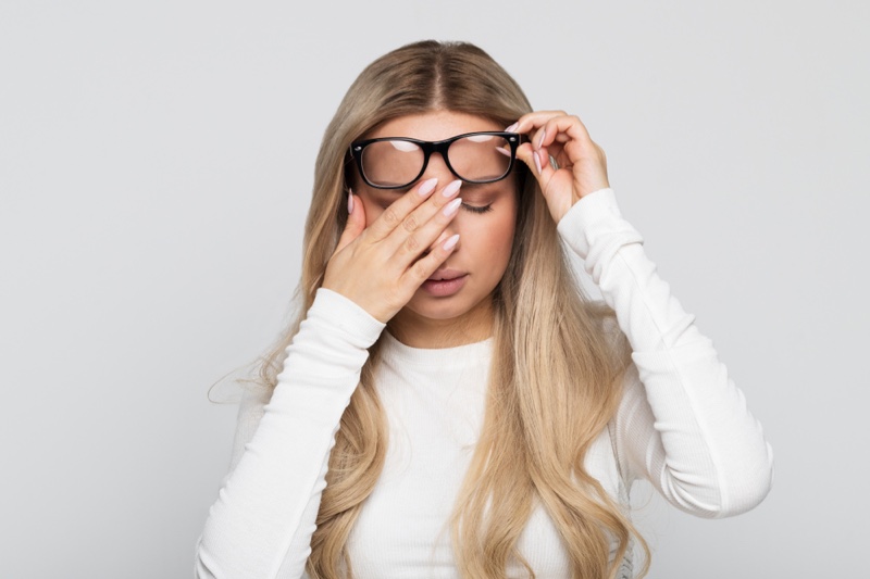 Blonde Woman Tired Eyes Raised Glasses