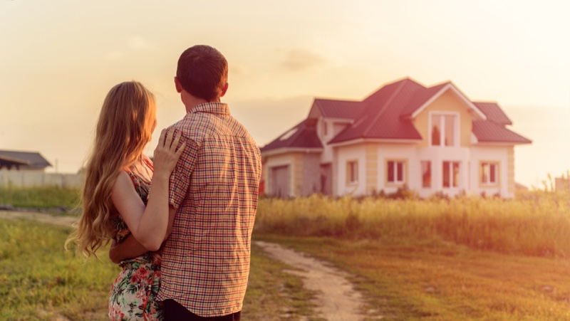 Couple Embracing Outside House