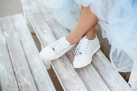 6 Expert Tips for Taking Care of Your Sneakers Cropped Woman White Sneakers Skirt