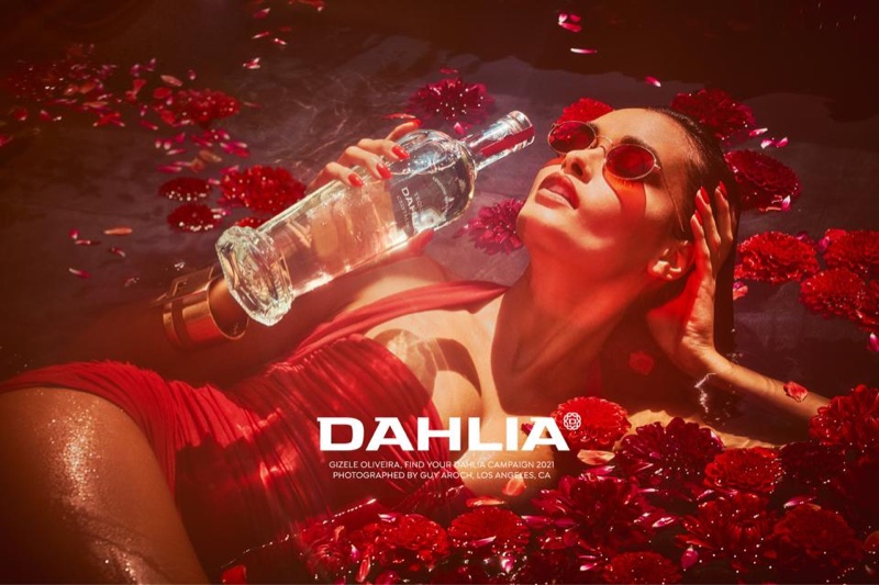 Wearing a red swimsuit, Gizele Oliveira poses for Dahlia Tequila campaign.