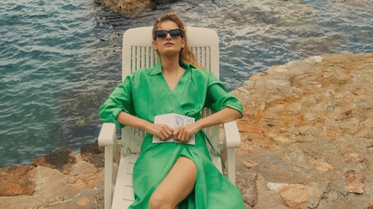 Posing with a book, Signe Veiteberg lounges in Massimo Dutti summer 2021 collection.