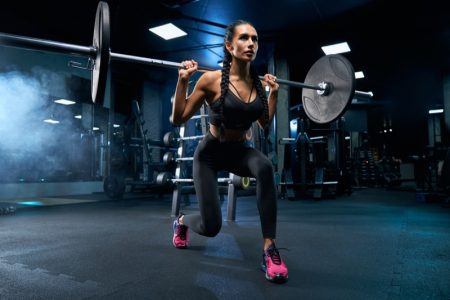 How Weightlifters Get Their Nutritional Needs Woman Lifting Weight Bar Lunge Workout Clothes