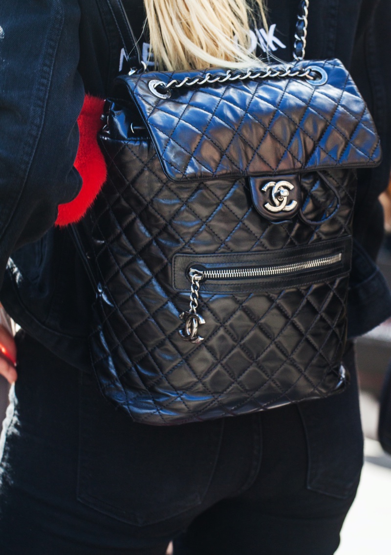 Woman Wearing Black Chanel Backpack Flap