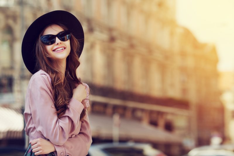 Woman Wearing Fedora and Sunglasses