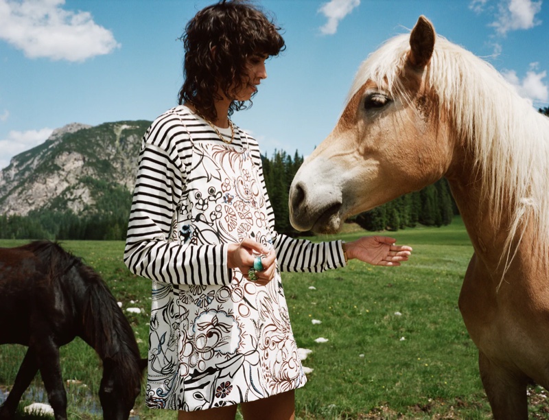 Posing with a horse, the model fronts Zara Sulle Dolomiti summer 2021 editorial.