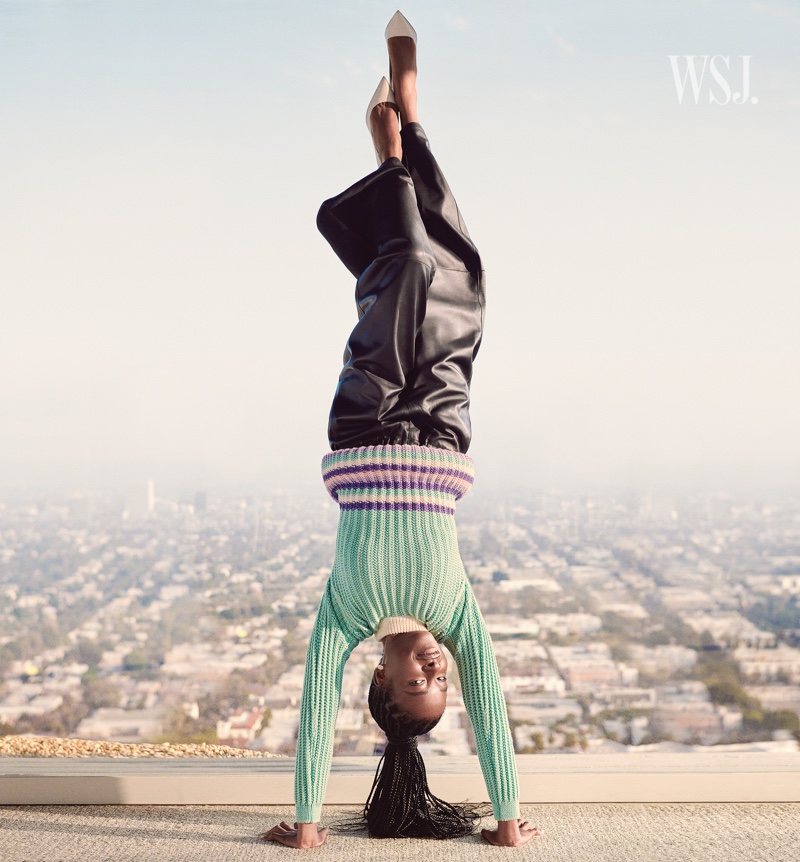 Doing a handstand, Amanda Gorman wears Loewe outfit. Photo: Cass Bird for WSJ. Magazine