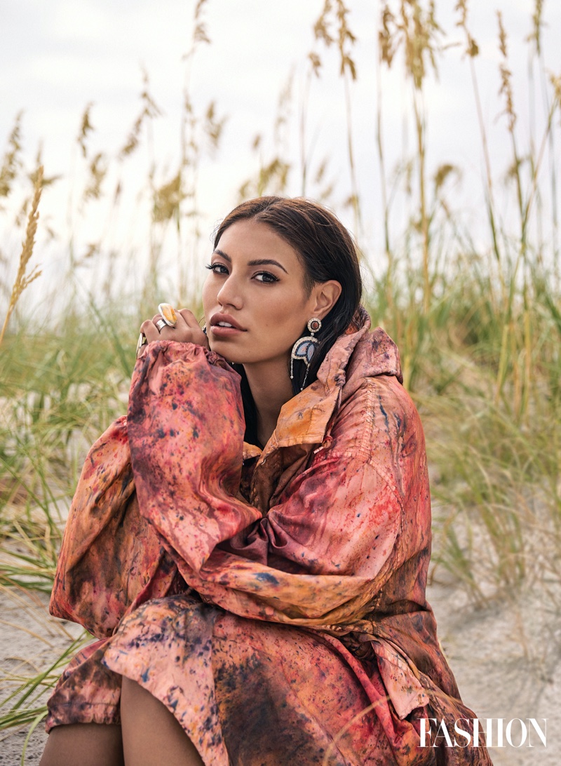 Actress and influencer Ashley Callingbull poses in 4Kinship jacket and rings.