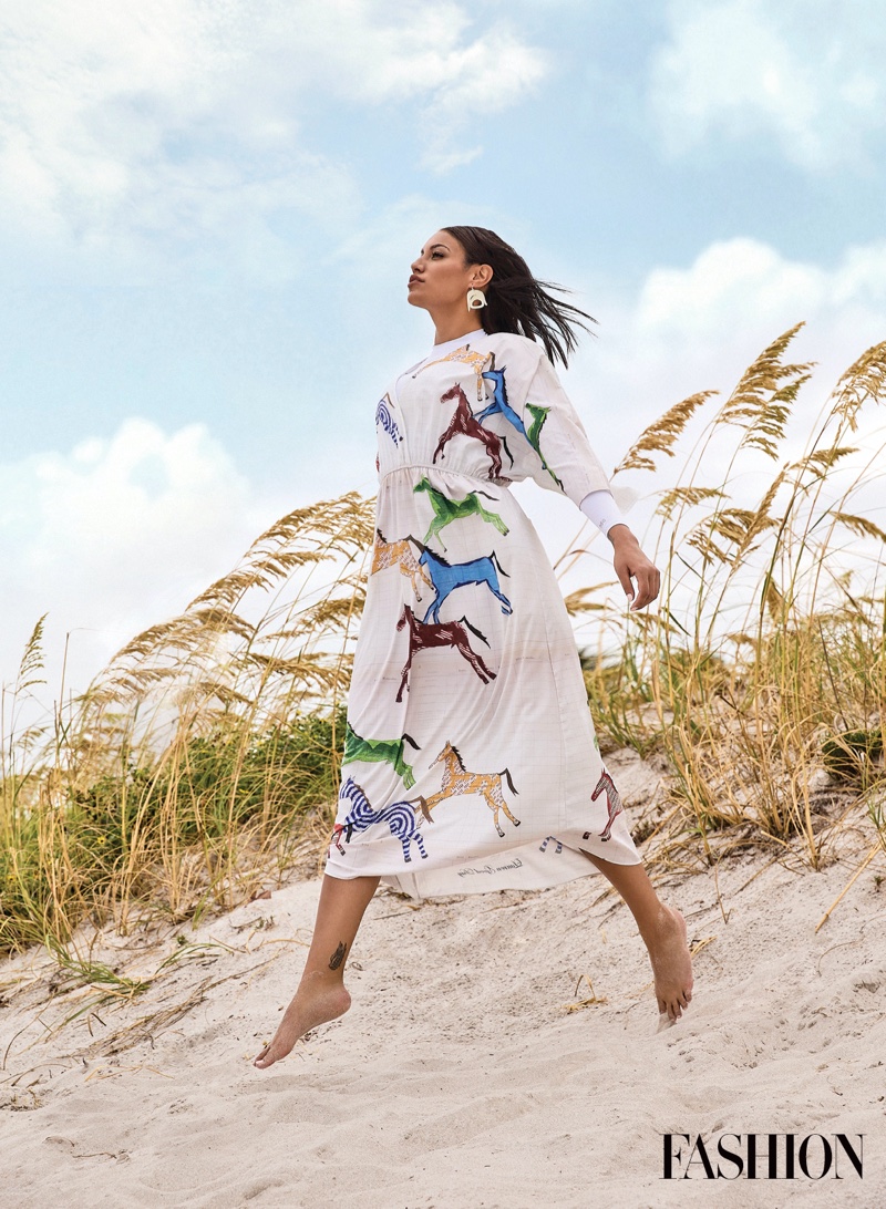 Posing barefoot, Ashley Callingbull wears Lauren Good Day dress and Warren Steven Scott earrings.