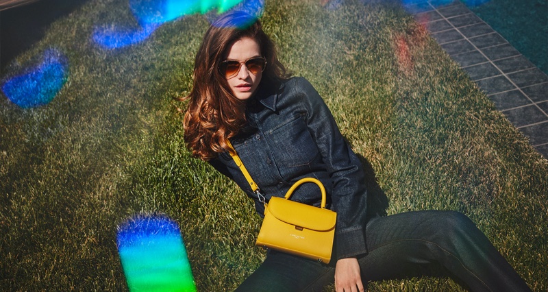 Lancaster highlights yellow mini handle bag in fall-winter 2021 campaign.