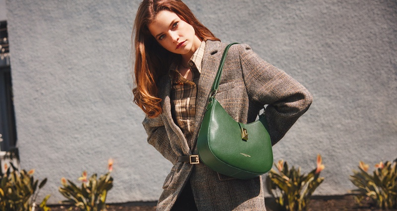 Posing with a pine green shoulder bag, Barbara Palvin fronts Lancaster fall-winter 2021 campaign.