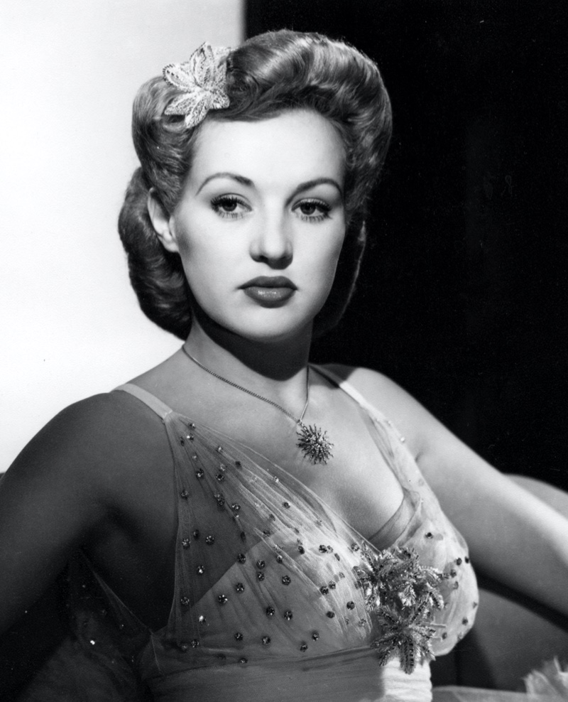 Actress Betty Grable poses with a sleek pompadour updo hairstyle. Photo: RGR Collection / Alamy Stock Photo