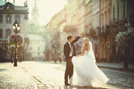 Expert Tips for Creating Wedding Websites in 2021 Bride Groom Cobblestone Streets Dancing Wedding Dress