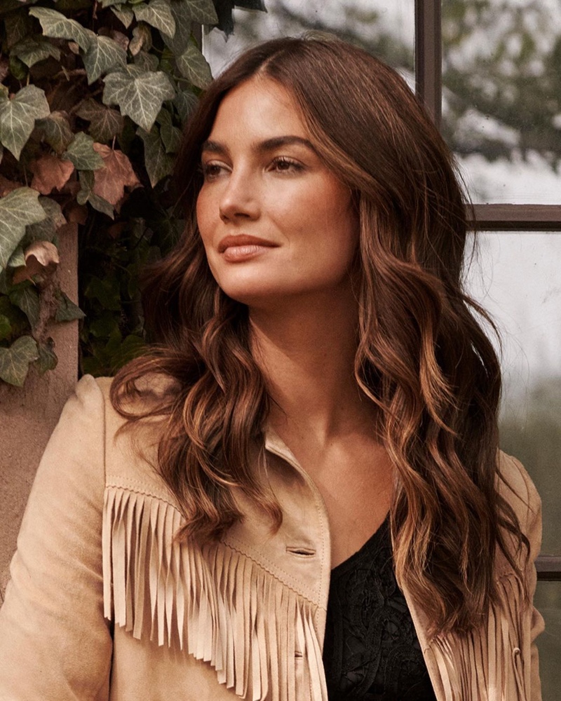 Model Lily Aldridge poses in fringed jacket for Lauren Ralph Lauren fall 2021 campaign.