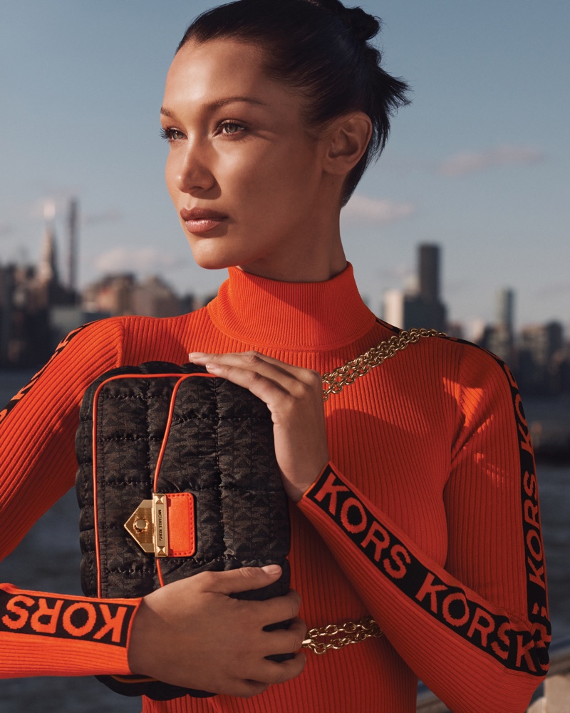 Posing with the SoHo bag, Bella Hadid fronts MICHAEL Michael Kors fall-winter 2021 campaign.