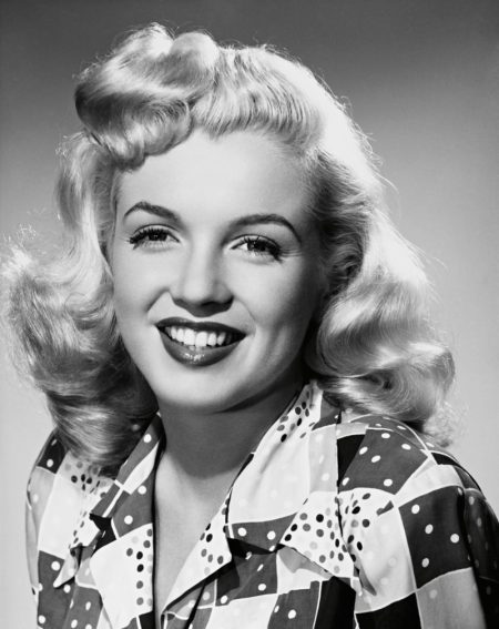 1940s Hairstyles and the Actresses That Wore Them Marilyn Monroe wears wavy and bouncy curls with her signature blonde hair in 1948. Photo: Album / Alamy Stock Photo