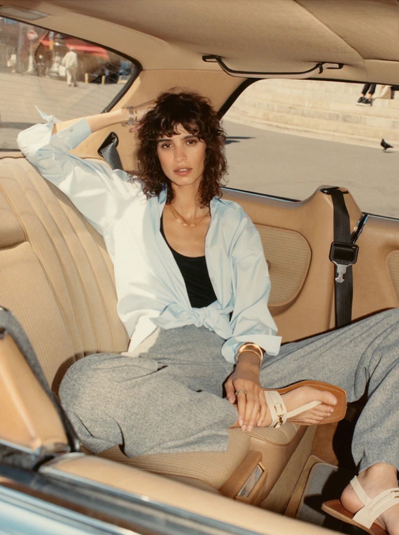 Posing in a car, Mica Arganaraz wears Massimo Dutti's fall 2021 styles.