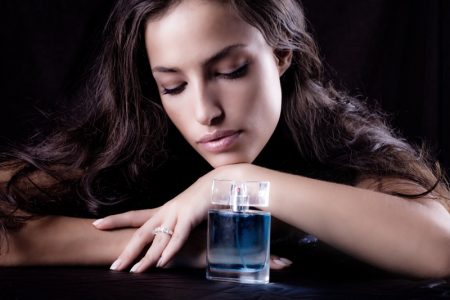 Perfume Shopping Tips: 7 Tips on Buying Perfume as a Present Model Dark Hair Perfume Bottle Blue