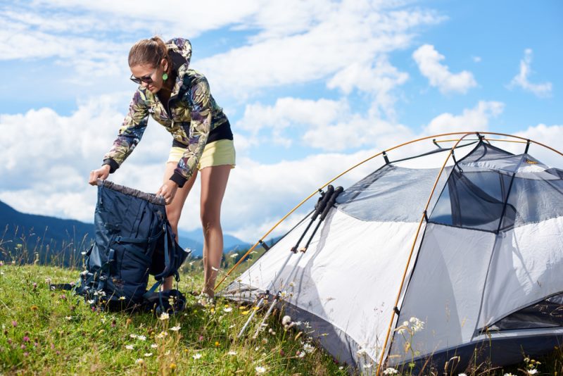 Woman Camping Opening Bag