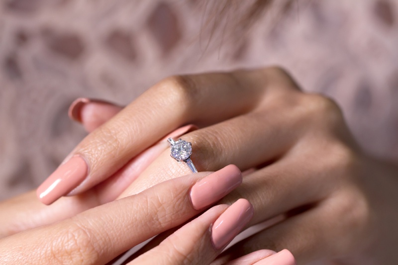 Woman Pink Nails Diamond Solitaire Engagement Ring