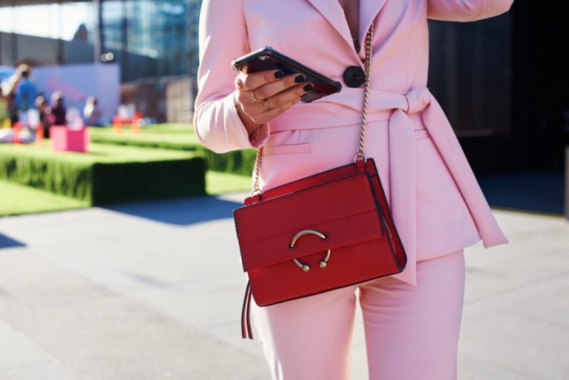 Woman in Pink Suit with Red Crossbody Bag