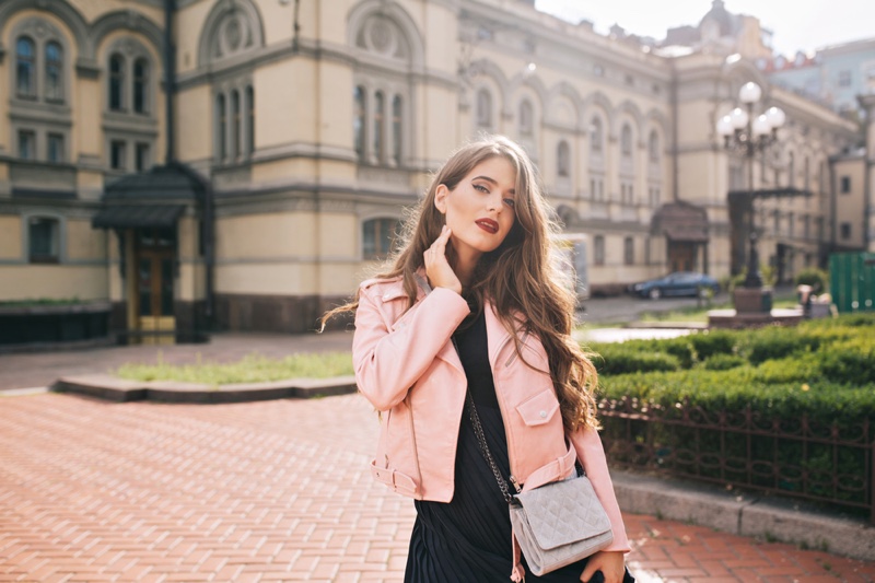 Young Woman Pink Leather Jacket Black Dress Crossbody Bag