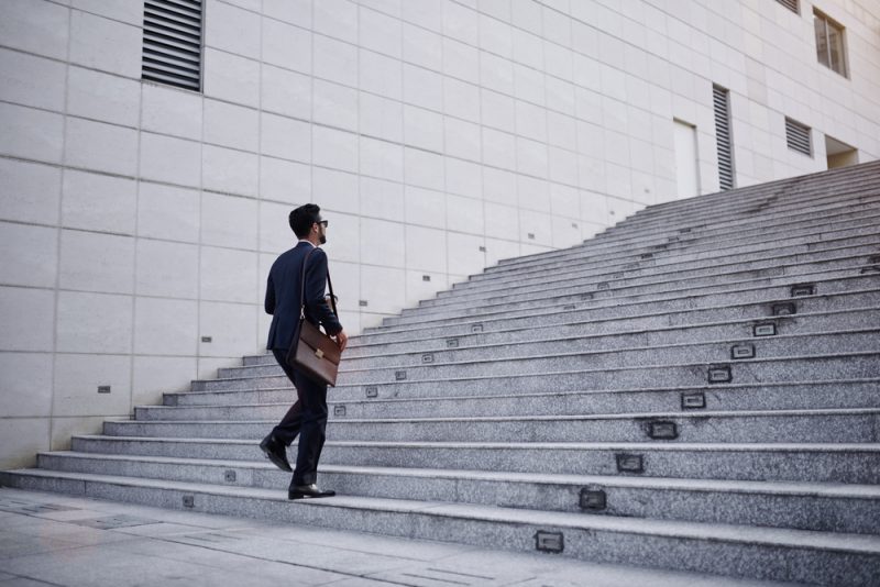 Man Going Upstairs with Briefcase