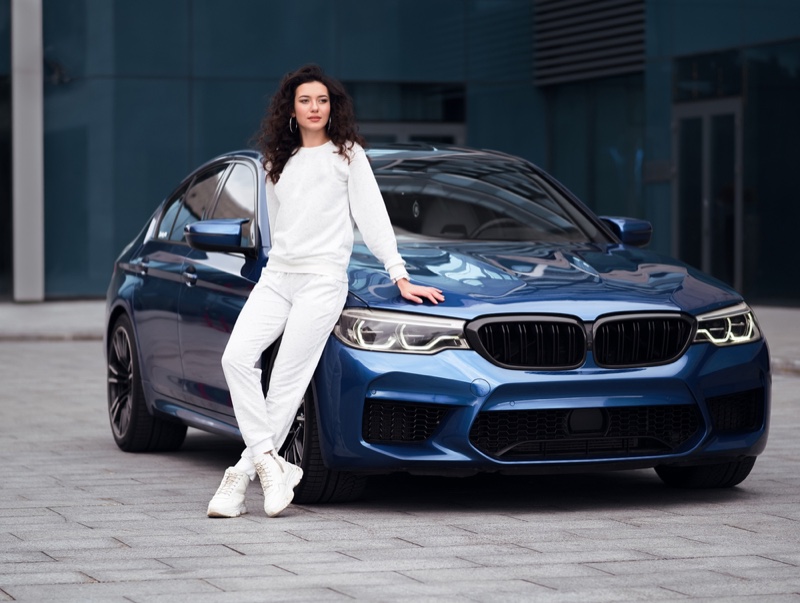 Model Posing Next Blue Car Casual Sneaker Outfit