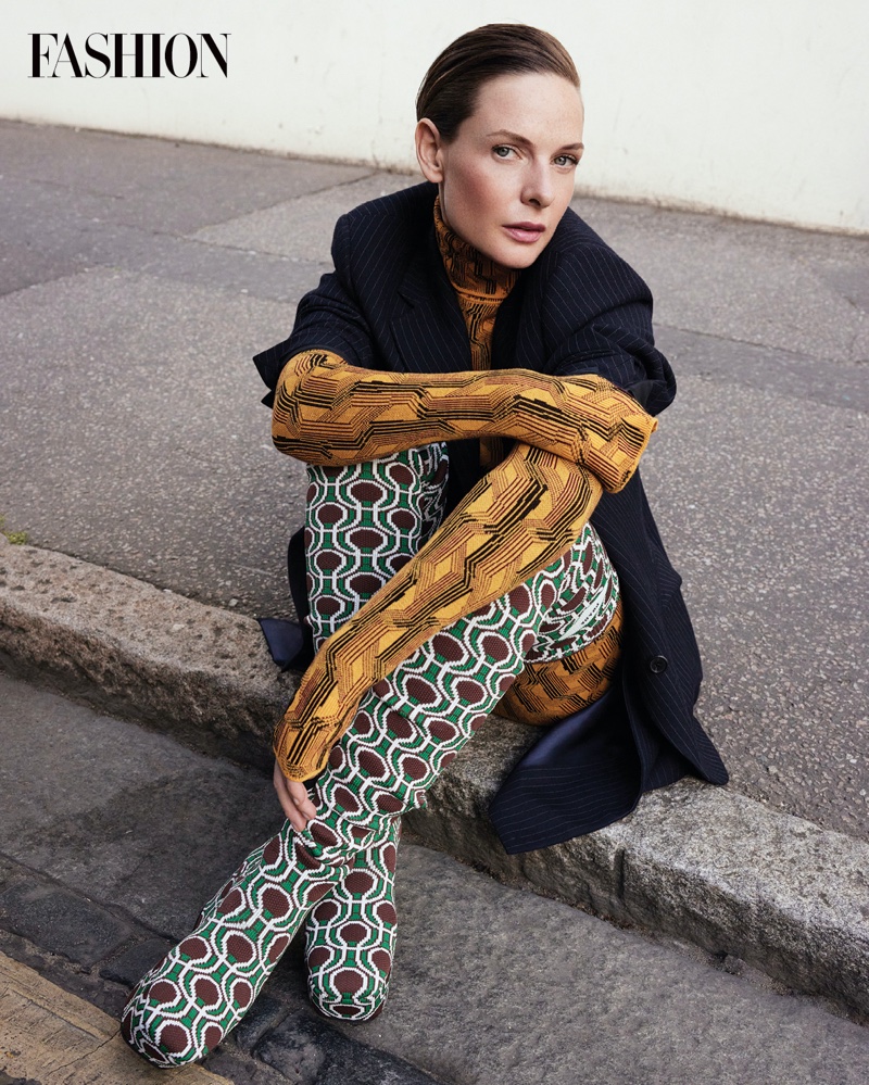 Dune actress Rebecca Ferguson poses in Prada jacket, bodysuit, skirt, and boots. Photo: Royal Gilbert / FASHION