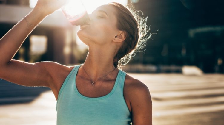 Woman Drinking Water Outside Sun
