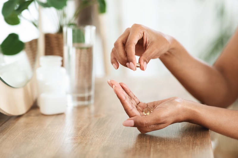 Woman Holding Fish Oil Pill Vitamins