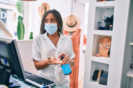 The Effects of the COVID-19 Pandemic on the Retail Industry Woman Wearing Mask Working at Retail Store