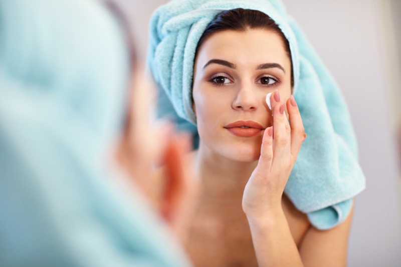 Young Woman Applying Product Face Towel Hair