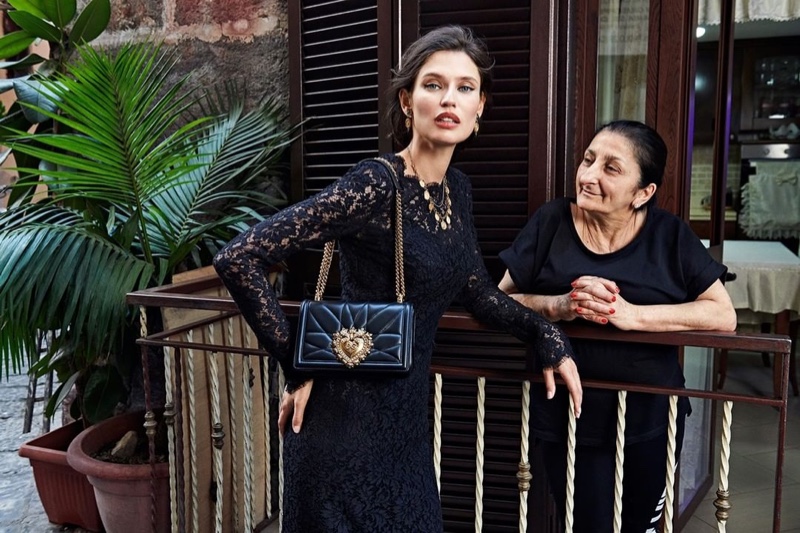 Bianca Balti wears Dolce & Gabbana lace dress and Devotion bag.